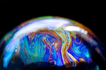 Abstract multicolored pattern, chaotic texture inside of the soap bubble, closeup
