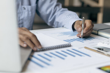 Businessmen use calculators to calculate budgets and analyze business profit growth. Financial planning and business accounting concepts.