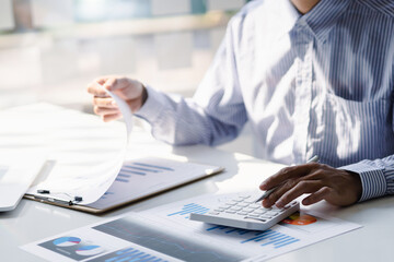 Accounting businessman working on paperwork and analyzing real estate investment data, Financial...