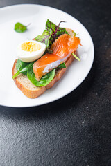 sandwich salmon smorrebrod egg, green salad mix, cereal bread toast seafood open fresh portion meal food snack on the table copy space food background 