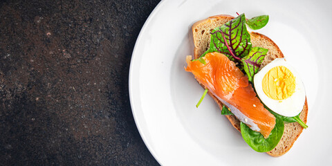 sandwich salmon smorrebrod egg, green salad mix, cereal bread toast seafood open fresh portion meal food snack on the table copy space food background 