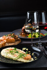 Top view of various Italian dishes with red and white wine