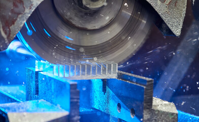 Cutting aluminium billet with machine.  .Circular milling machine cutting metal profile..Steel industry.