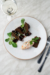 Directly above photo of gourmet salmon, garnished with boiled beetroot and rye croutons, modern russian cuisine