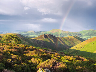 Scenic view of a rainbow on the green Long Mynd, Shropshire, England