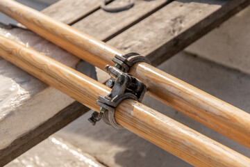 Closeup of two wooden oars on the dock.