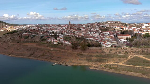 Aerial images of the Extremadura town of Alange from the reservoir. The image approaches descending to the pier of the village.