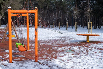 Beautiful children playground in the snow in winter