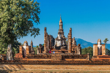 Closeup of Buddha statue in the ancient ruins of Sukhothai temple in Thailand