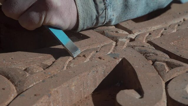 The hand carving stone process. Sculpture with a sculpting tool․ Stone sculpture carving.  Master carving cross stone   Khachkars are characteristic of Medieval Christian Armenian art.