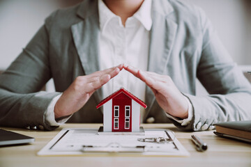 Property investment concept. Real estate broker with home insurance policy about house contract.