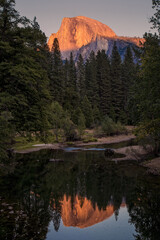 View of Half Dome Yosemite at sunset with mirroring river