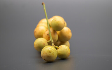 Baccaurea motleyana is a species fruit on black background