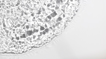 Grayscale top view shot of single wave from left upper corner making ripples and on water surface | cosmetic background, sunscreen commercial