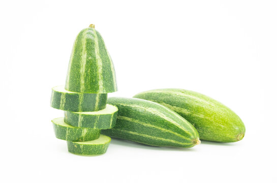 chopped and two whole pointed gourd isolated on white background, selective focus
