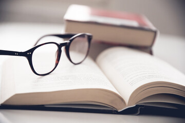 Closeup of glasses on a book