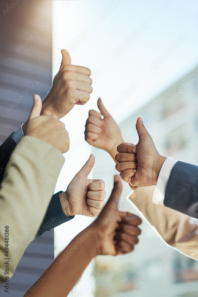 Poster its a thumbs up from us. shot of a group of hands showing thumbs up.