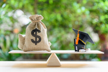 Money cost saving for goal and success in school, education concept : US dollar bills / cash in...