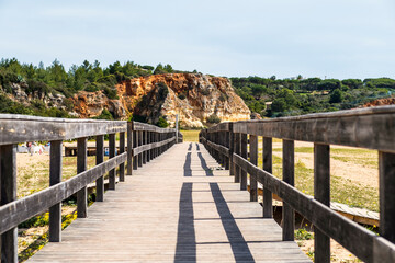 Fototapeta premium Wooden bridge on the beach of Ferragudo, Algarve, Portugal