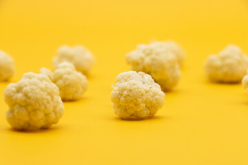 Cauliflower pieces isolated on yellow background, food, vegetable , side view