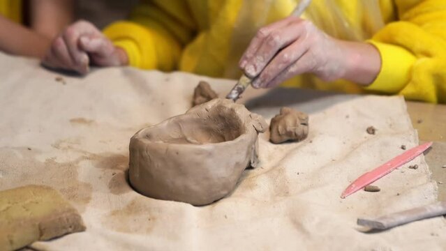 hands sculpt a figurine or sculpture of clay. developmental and creative activities with children. pottery workshop. a hobby for the whole family.