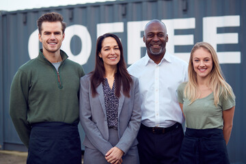 Portrait Of Multi-Cultural Freight Haulage Team Standing By Shipping Container