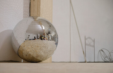 Mirror disco ball on the floor in the club. Installation of a nightclub.	