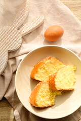 Plate of traditional sweet bread, eaten at Easter time in Croatia. Easter bunny, eggs and flowers on the table. Top view.