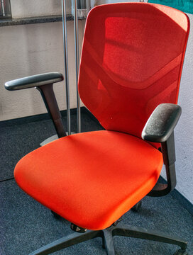 Vertical Shot Of A Red Computer Chair In A Room