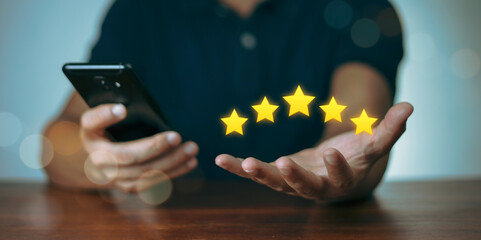 Male Customer Assessment Feedback gives a positive review for Customer Satisfaction Survey. five star rating with a smartphone service rating Satisfaction Concept