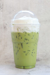 Green tea milk iced fresh drink on marble background,