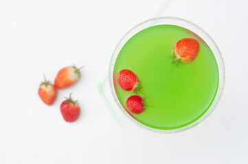 Colorful bright green cocktail cactus with strawberries, delicious refreshing
