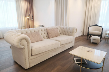 White leather sofa in the old style in the interior