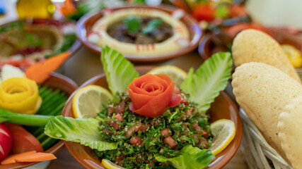 Fototapeta na wymiar Multiple lebanese appetizers and salads together on the table. focused on tabbouleh