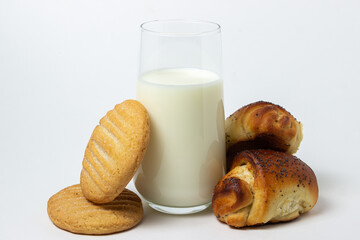 Glass of milk on a white background. Delicious breakfast with milk and homemade cakes. Healthy diet