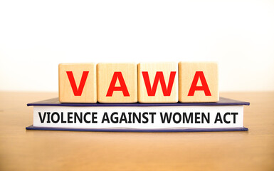 VAWA violence against women act symbol. Concept words VAWA violence against women act on cubes....