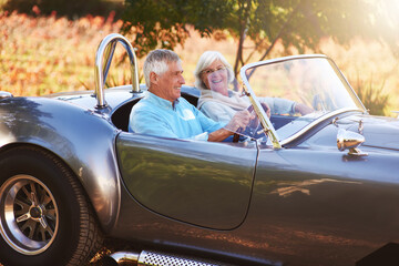 Taking a drive through the countryside. Cropped shot of a senior couple driving through the countryside.
