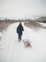 A boy with a sled