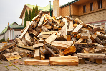 A pile of split firewood for heating the house.