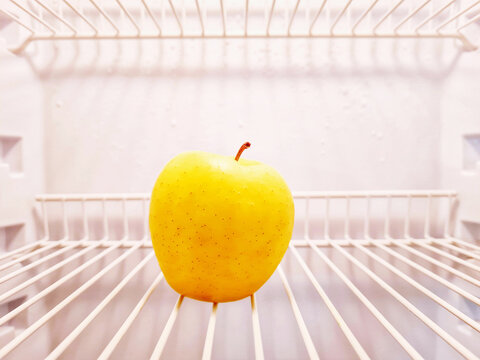Close-up of apple inside the empty fridge
