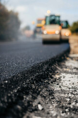 Blurred background of vibratory asphalt rollers compactor compacting new asphalt pavement. Road service building new highway