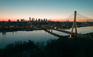 Dark moody photo of the city of Warsaw in Poland in the sunset, blue hour, from Praga side of the...