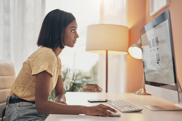 The home business industry is booming. Shot of a young woman using a computer while working from...