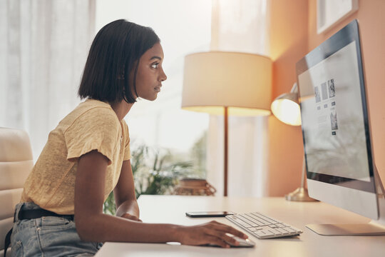 The Home Business Industry Is Booming. Shot Of A Young Woman Using A Computer While Working From Home.