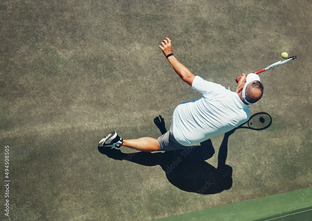 Sticker that was close. high angle shot of a focused middle aged man playing tennis outside on a tennis cour