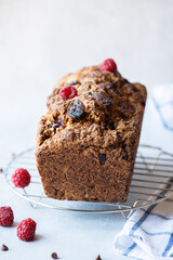 Vanilla cake with chocolates and raspberry.  Close up.
