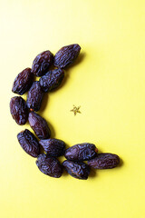 Shape of moon from dates and glowing glitter. Top view.