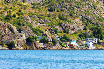Fototapeta premium Houses along the water's edge, at the base of Signal Hill, St. John's Harbour, The Battery, St. John's, NL