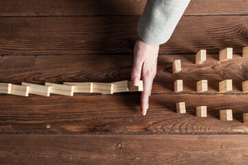 Business woman block domino effect.