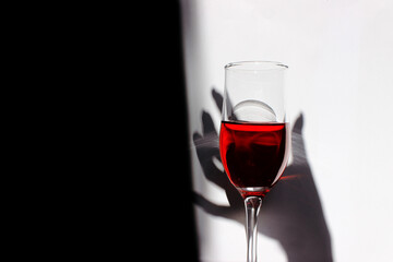 Silhouette of a woman and a glass of wine